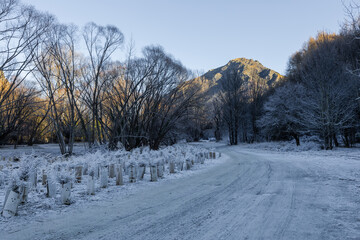 Snowy walking track with a mountain view in the background.