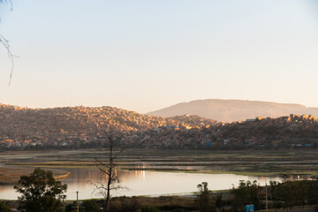 View of a lagoon at sunset, lagoon surrounded by mountains, cochabamba city bolivia