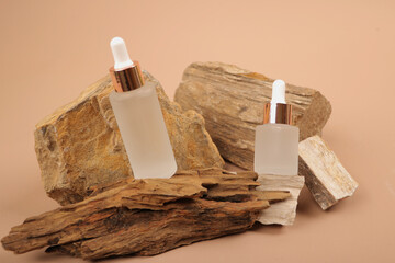 Frosted and Amber White Bottles on Natural Rock Elements