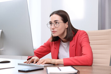 Woman with poor posture working in office