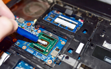 Applying thermal paste to a chip in a computer. Thermal grease syringe apply thermal compound to a...