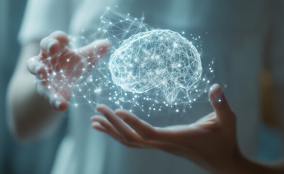 A glowing digital brain hologram suspended above an outstretched hand, symbolizing advanced technology and innovation.