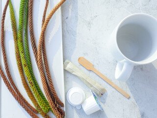 Flat layout of a glass on a napkin, wooden coffee stick, coffee stick, liquid coffee creamers and...