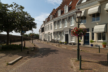 Narrow street along historic monumental buildings in the fortified town of Wijk bij Duurstede.