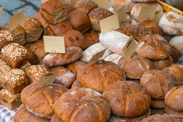 Different types of fresh bread on display at farmers market on Vltava riverside near Palackeho namesti, Prague, Czech Republic (Czechia), Europe