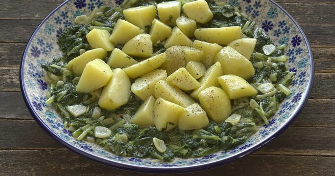 South Croatian Blitva dish. The dish is made with boiled potatoes, swiss chard, garlic, and olive oil.  Table spin.