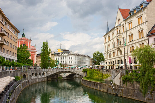 A stretch of the River Ljubljanica leading towards the Triple Bridge, designed in 1932 by Joze Plecnik, and city centre, Ljubljana, Slovenia, Europe