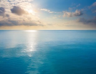 Closeup surface of calm ocean blue sea water with sunshine and clouds behind. Abstract Background Texture.