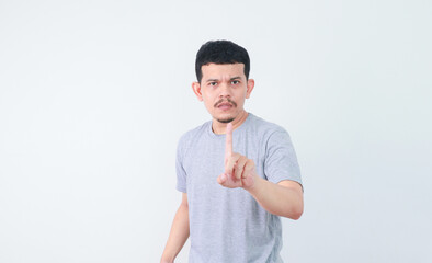 an asian man shows a refusing gesture or a no sign