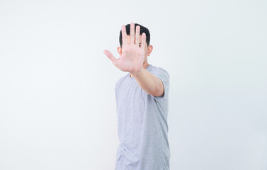 an asian man shows a refusing gesture or a no sign