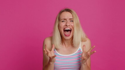 Irritated angry Caucasian young woman 30 years old screams from stress tension problems feels...