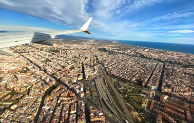 View of city from airplane window. Roofs of hoses and residential buildings from window of...