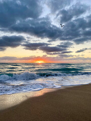 sunrise over the beach with orange sun