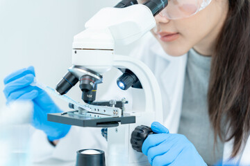 Scientist analyze biochemical samples in advanced scientific laboratory. Medical professional use microscope look microbiological developmental of viral. Biotechnology research in science lab.