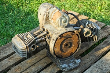 one old dirty disassembled powerful  rusty two-stroke heavy engine removed from a retro motorcycle...