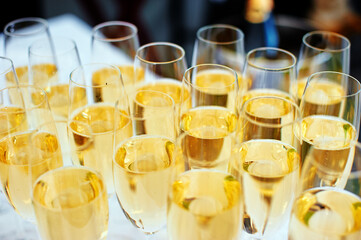 Table setting for party. Wineglasses with white wine.