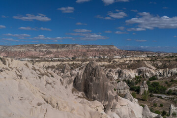 A serene landscape with the iconic fairy chimneys of Cappadocia, Turkey, under a vibrant blue sky...
