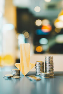 Down arrow with coin stack. Key concepts for success, methods, systems of raising or lowering Fed interest rates to correct inflation concepts.