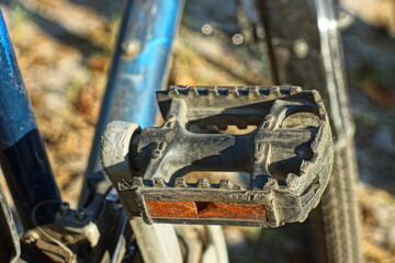 one plastic broken old with orange reflector black with iron lever foot pedal with blue frame and front wheel of sport bike daytime outdoors