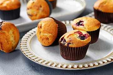Freshly baked blueberry muffins on gray plate