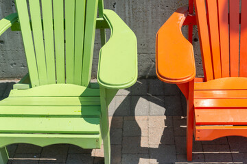 close-up detail of very comfortable and relaxing green and orange outdoor chairs made of wood...
