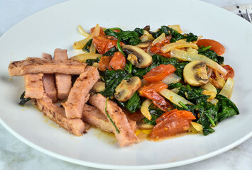spam fries served with sauteed spinach dish