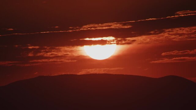 Extreme Closeup of Red Sun Rising Over a Hill Zoom In Timelapse