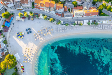 Drone view of the beach in the morning light. Holiday moments on the beach in Primosten, Croatia.