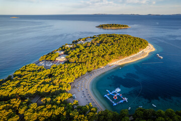 Aerial view of the peninsula surrounded by a wonderful beach with azure water in Primosten, Croatia.