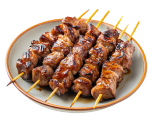 A plate of meat skewers with a wooden stick on each one. The plate is on a white background