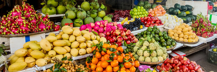 A vibrant market stall showcasing a diverse array of tropical fruits, perfect for healthy eating and celebrating ethnic food festivals