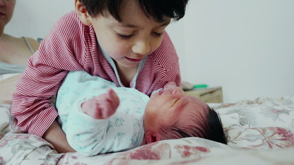 Brother and newborn baby authentic interaction during initial days of life of new member of the...