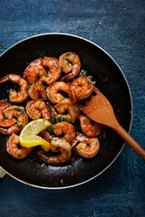 fried tiger prawns, jumbo, in garlic sauce, in butter, with herbs, in a frying pan, homemade, no people,