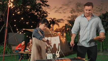 Family gather celebrate holiday, Adorable child grill food for family member. Outdoor camping...