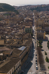 Fototapeta premium Cityscape of small town in mountains on a sunny spring day, Scicli, Sicily, Italy
