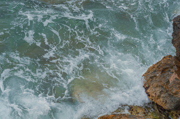 ocean waves crashing on rocky shore