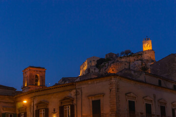 Townscape of the houses and castle Castello dei Conti in the city during blue hour at evening...