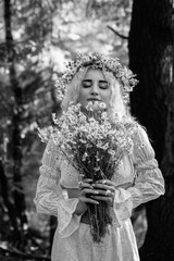 Obraz premium Portrait of a young beautiful blonde girl in nature. Black and white photo.