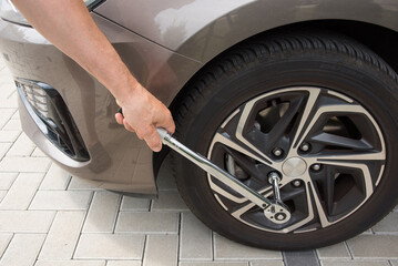 Man pulling in tyre with a torque moment wrench