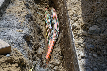 Underground cable with several optical fibers laid in a trench in the excavated sidewalk, communication and infrastructure concept, copy space