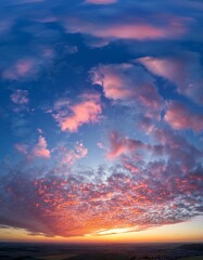 Fototapeta premium Ideal for Sky replacement project: Panoramic, colorful pink-orange-blue dramatic sky with clouds illuminated by red sunset, aerial photography, far horizon without obstacles.