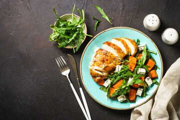 Healthy salad with baked chicken breast, pumpkin, blue cheese and arugula. Healthy diet food.