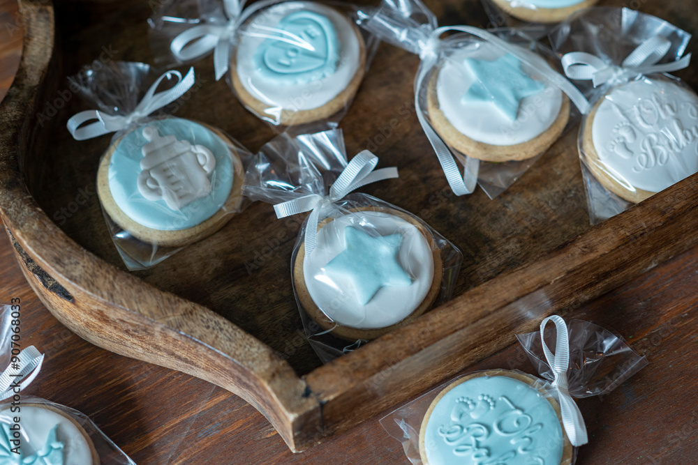 Wall mural top view image of cookies wrapped with blue ribbon in cellophane and decorated with blue and white i