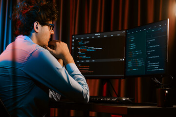 Working IT developer concentrating online software development information on surrounded by coding...