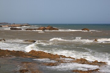 waves on the beach, rocky coastline