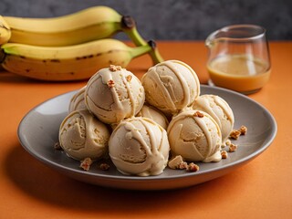 Banana ice cream balls in nice plate on orange and grey background. Plate of banana ice cream balls on vibrant backdrop