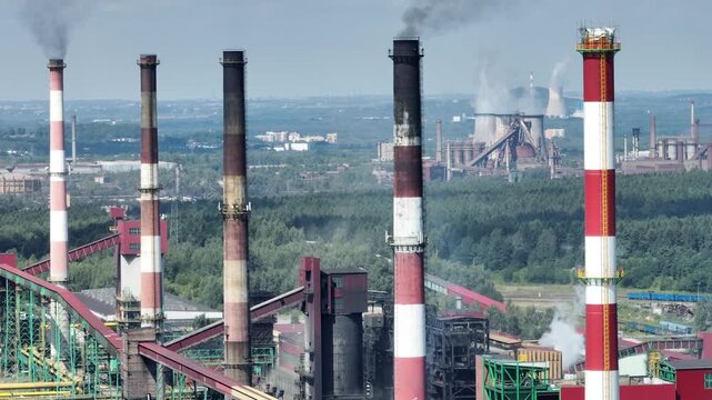 Aerial drone view Coking Plant factory. Coke plant. Heavy industry in Europe, Poland, Dabrowa Gornicza. Air pollution from chimneys. Close up shot of the chimneys from the steelworks coking plant.