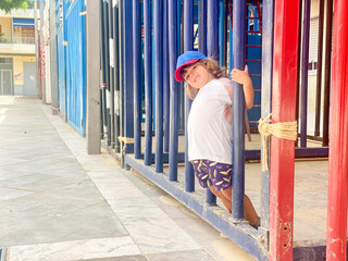 Child playing on the bleachers of a portable bullring
