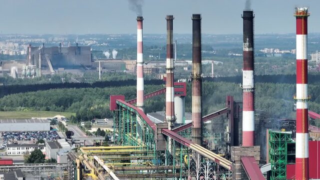 Aerial drone view Coking Plant factory. Coke plant. Heavy industry in Europe, Poland, Dabrowa Gornicza. Air pollution from chimneys. Close up shot of the chimneys from the steelworks coking plant.