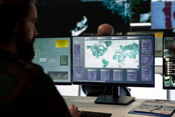 Trooper examines surveillance radar CCTV imagery in control center, monitoring the deployed...